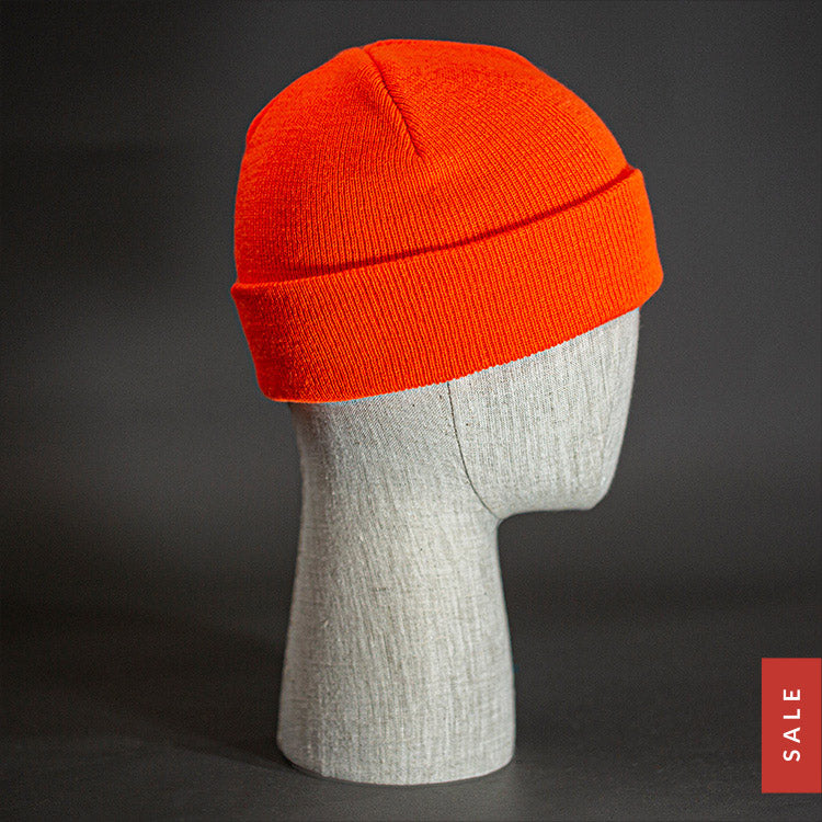 The Longshore Beanie, a blaze orange colored, tight knit, short length blank beanie. Designed by Blvnk Headwear.