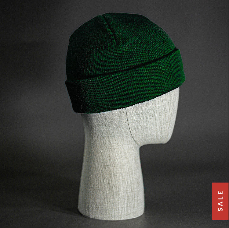 The Longshore Beanie, a dark green colored, tight knit, short length blank beanie. Designed by Blvnk Headwear.