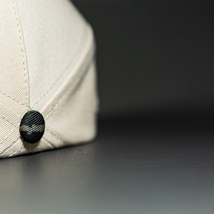 all-groups Blvnk Headwear Origin Vintage Shape blank Snapback in Natural and Realtree Original Camo button close up.