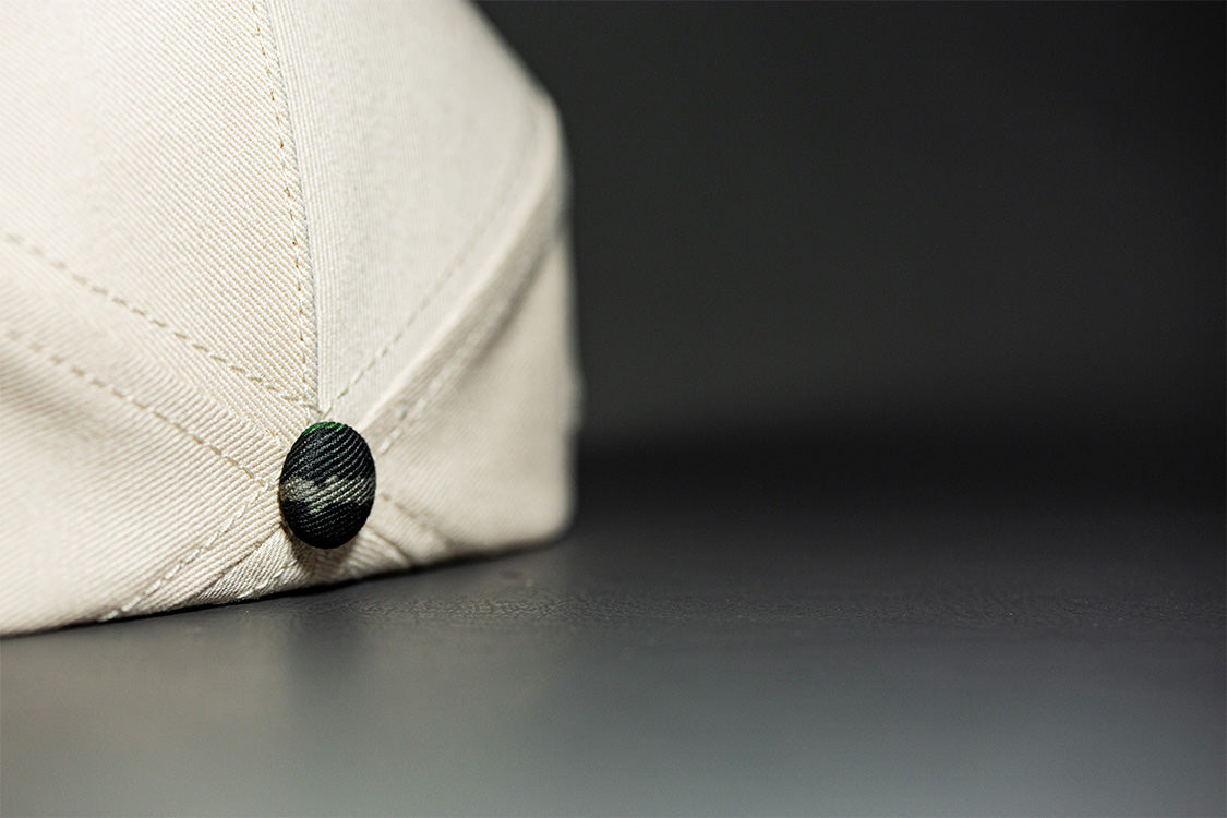 all-groups Blvnk Headwear Origin Vintage Shape blank Snapback in Natural and Realtree Original Camo button close up.