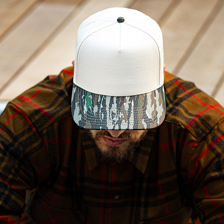 all-groups Blvnk Headwear Origin Vintage Shape blank Snapback in Natural and Realtree Original Camo on man in a flannel.