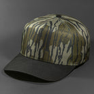 The Blvnk Headwear Vision Vintage Shape Blank Snapback in the Mossy Oak Bottomland and Black Suede color way.