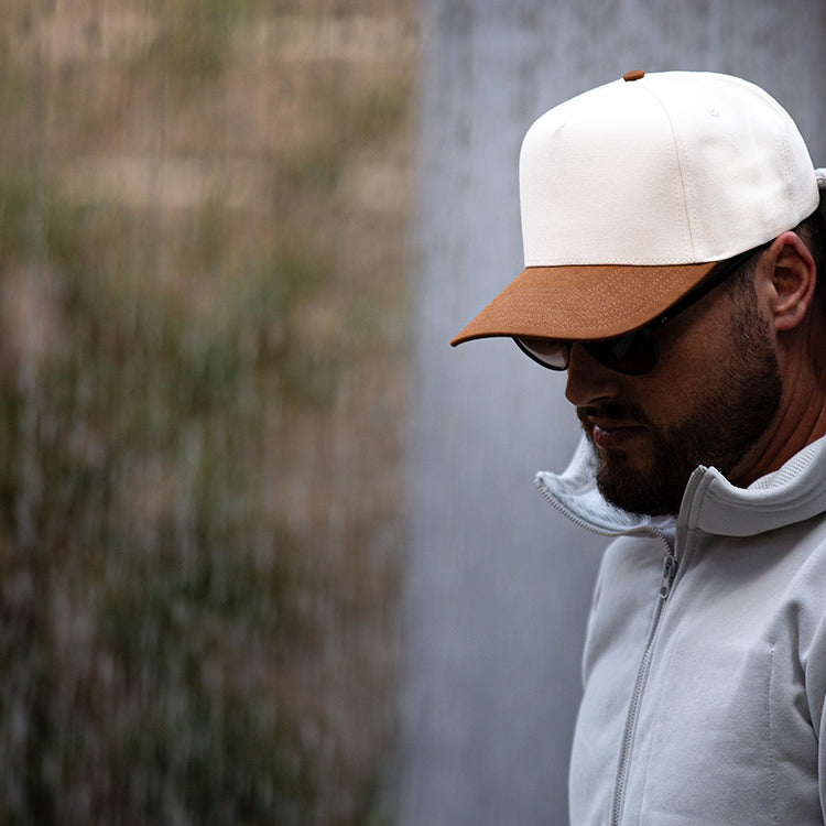 all-groups Blvnk Headwear Vision Vintage Shape Snapback Hat NATURAL BROWN SUEDE on man in hooded sweatshirt.