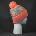 Flakey blank snowflake jacquard pom beanie in Coral Pink and Sea Foam by Blvnk Headwear