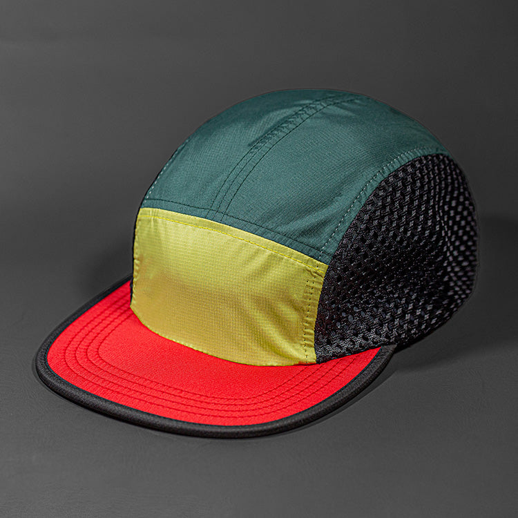 The Ultra Tech blank performance 5 Panel Runners Cap in Lion Yellow, Grove, Black and Red by Blvnk Headwear.