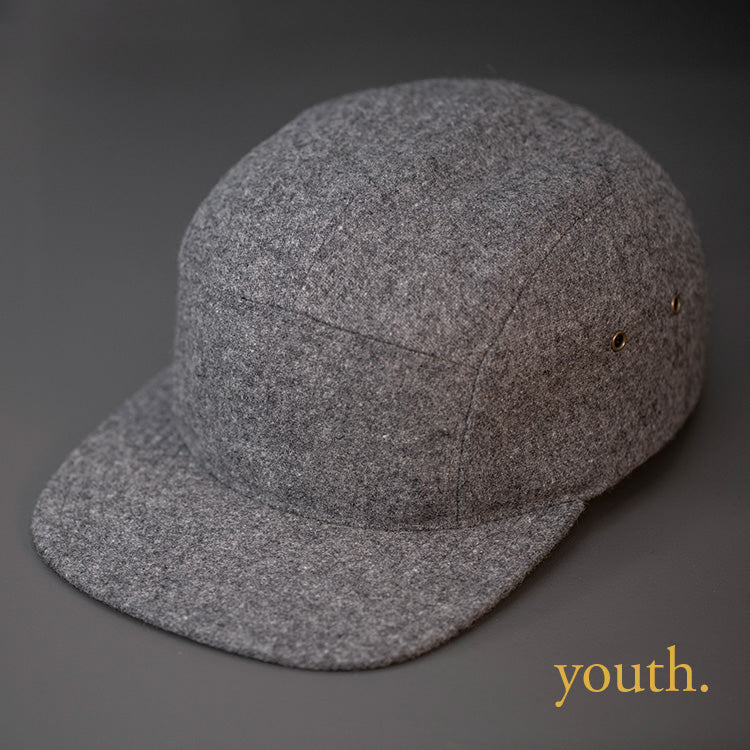 A Youth Sized, Warm, Heather Grey, Melton Wool, Blank 5 Panel Camp Hat With a Flat Bill, & Leather Strapback.
