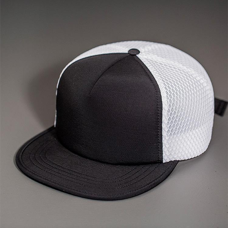 A Water Resistant Nylon, Blank Trucker Hat with a Packable Flotation Bill with a Hydro Mesh back & Woven Nylon Strapback. | Black & White Colorway by BLVNK Headwear.