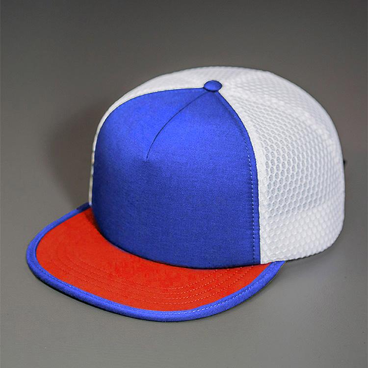 A Water Resistant Nylon, Blank Trucker Hat with a Packable Flotation Bill with a Hydro Mesh back & Woven Nylon Strapback. | Blue Ribbon, White & Red Colorway by BLVNK Headwear.