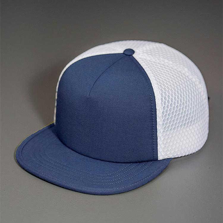 A Water Resistant Nylon, Blank Trucker Hat with a Packable Flotation Bill with a Hydro Mesh back & Woven Nylon Strapback. | Navy & White Colorway by BLVNK Headwear.