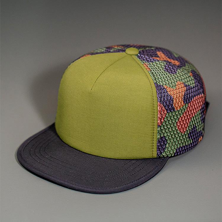 A Water Resistant Nylon, Blank Trucker Hat with a Packable Flotation Bill with a Hydro Mesh back & Woven Nylon Strapback. | Olive, Camo & Black Colorway by BLVNK Headwear.