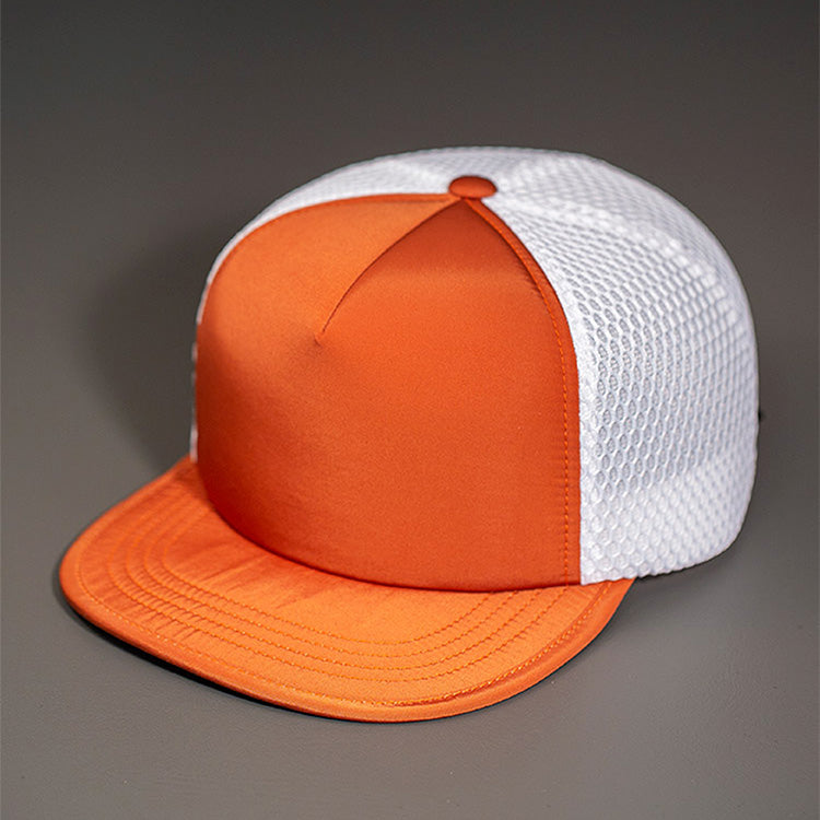 A Water Resistant Nylon, Blank Trucker Hat with a Packable Flotation Bill with a Hydro Mesh back & Woven Nylon Strapback. | Rust & White Colorway by BLVNK Headwear.