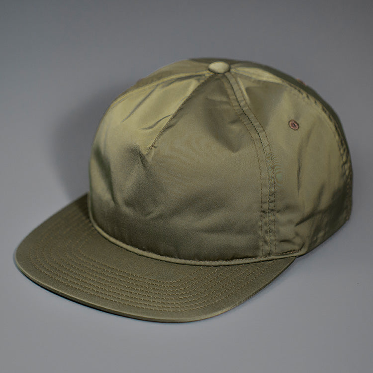 An Olive, Unstructured Satin Nylon, Blank Hat W/ a Pinch Front Crown, Flat Bill & a Classic Snapback. | Designed by Blvnk Headwear