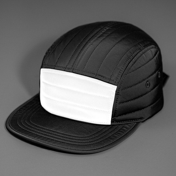 A 3M Reflective & Black Quilted Nylon, Blank 5 Panel Camp Hat featuring a Packable Visor, Satin Lining & a Woven Nylon Backstrap. | Designed by Blvnk Headwear