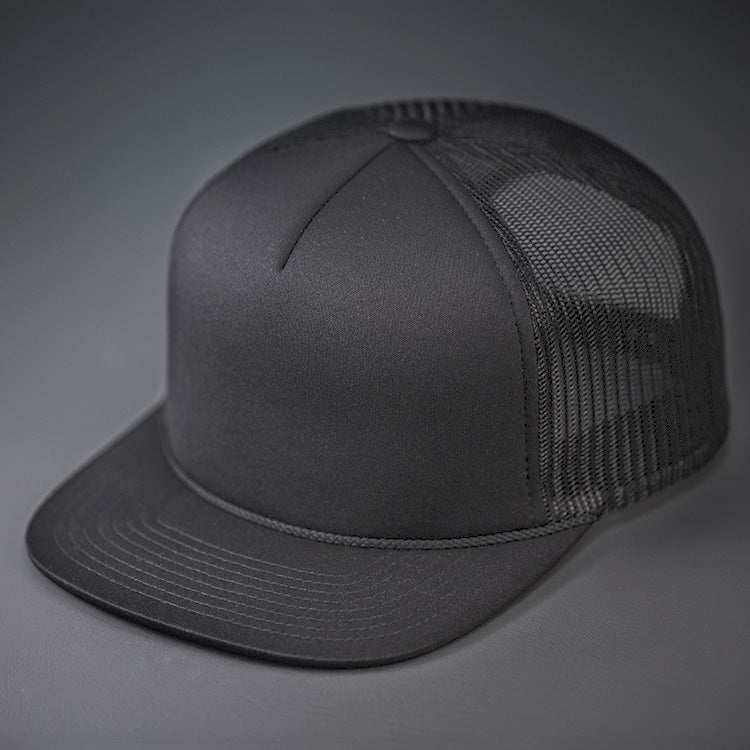 A Charcoal, Foam Front, Mesh Backed Blank Trucker Hat with a Flat Bill, & Classic Snapback. Designed by Blvnk Headwear.