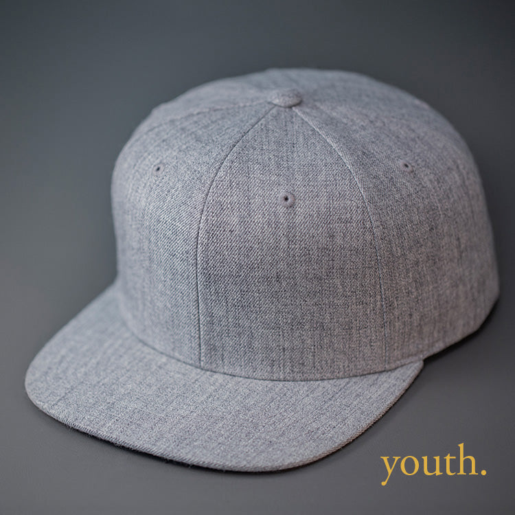A Youth Sized, Heather Grey, Wool, 6 Panel, Flat Bill, Blank Snapback.  Designed by Blvnk Headwear.