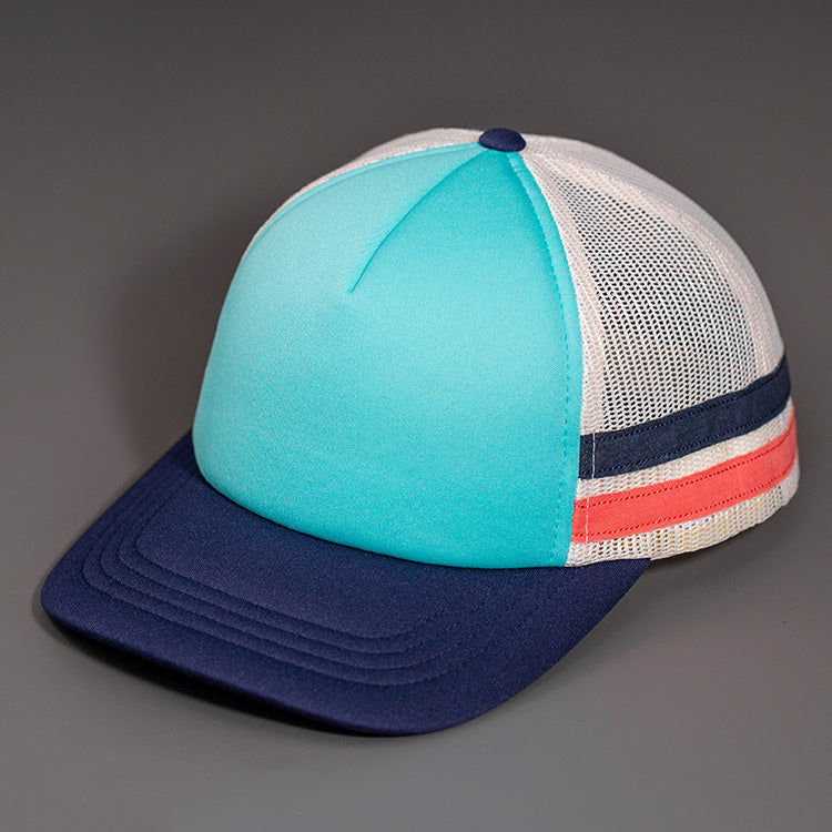 A Sea Foam Low Profile Foam Front, Coral & Navy Striped, Birch Mesh Back, Blank Trucker Hat with a Navy Blue Curved Bill, & Classic Snapback. Designed by Blvnk Headwear.