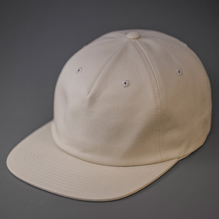 A Birch, Unstructured, Premium Cotton, Blank Pinch Front Hat With a Vegan Leather Back Strap & Brass Clasp. Designed By Blvnk Headwear.