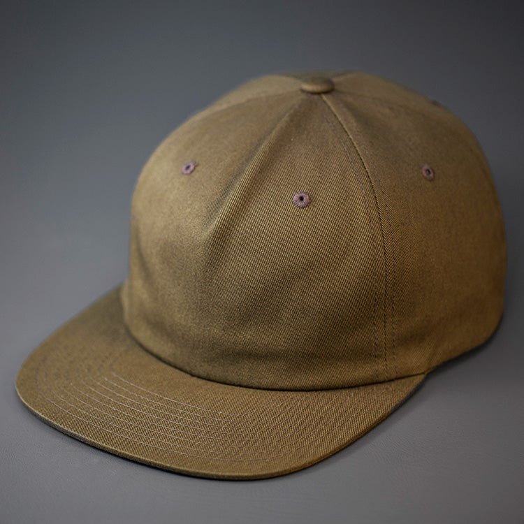 A Buck Green, Unstructured, Premium Cotton, Blank Pinch Front Hat With a Vegan Leather Back Strap & Brass Clasp. Designed By Blvnk Headwear.