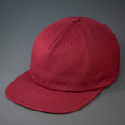 A Pale Maroon, Unstructured, Premium Cotton, Blank Pinch Front Hat With a Vegan Leather Back Strap & Brass Clasp.  Designed By Blvnk Headwear.