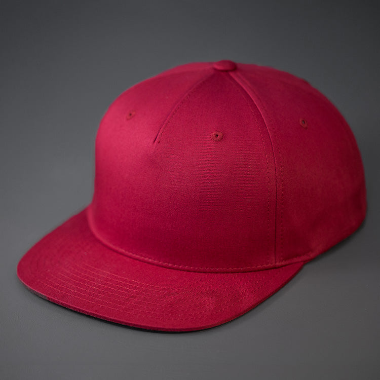 A Berry Colored, Cotton Twill, Pinch Front, Blank Snapback Hat. Designed & Manufactured by Blvnk Headwear.