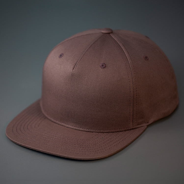A Brown Colored, Cotton Twill, Pinch Front, Blank Snapback Hat. Designed & Manufactured by Blvnk Headwear.