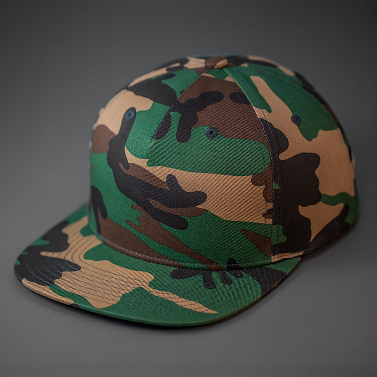 A Camo Colored, Cotton Twill, Pinch Front, Blank Snapback Hat. Designed & Manufactured by Blvnk Headwear.