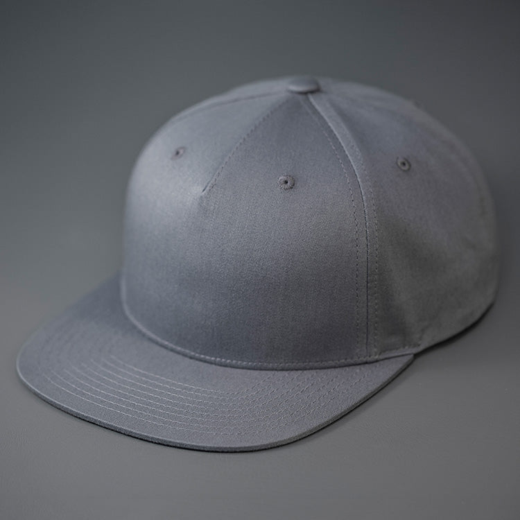 A Flint Grey Colored, Cotton Twill, Pinch Front, Blank Snapback Hat. Designed & Manufactured by Blvnk Headwear.