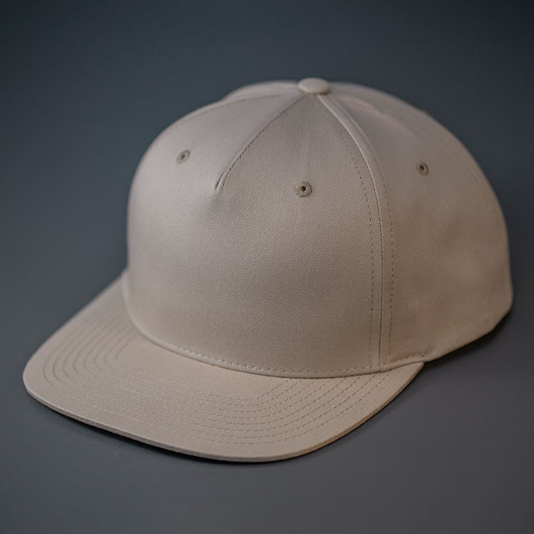 A Khaki Colored, Cotton Twill, Pinch Front, Blank Snapback Hat. Designed & Manufactured by Blvnk Headwear.