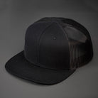 A Black, Blank Trucker Hat, With Black Mesh Back Panels, Flat Bill & Classic Snapback.  Designed by Blvnk Headwear.