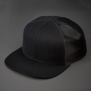 A Black, Blank Trucker Hat, With Black Mesh Back Panels, Flat Bill & Classic Snapback.  Designed by Blvnk Headwear.
