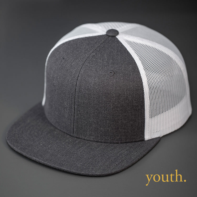 A Youth Sized, Heather Charcoal Wool Crown, Blank Trucker Hat, With White Mesh Back Panels, Flat Bill & Classic Snapback. Designed by Blvnk Headwear.