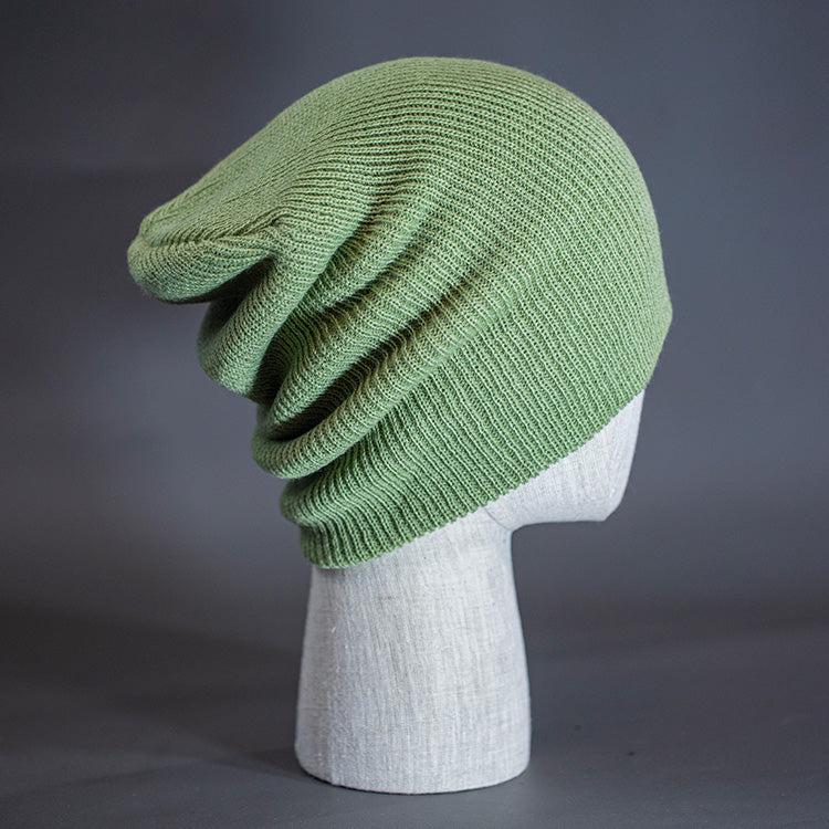 A Sage colored, super slouch knit blank beanie. Designed by Blvnk Headwear.