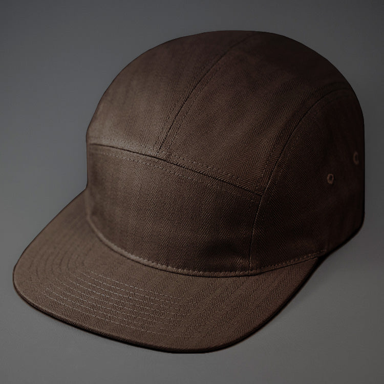 A Slate, Herringbone, Blank 5 Panel Camp Hat With a Flat Bill. Designed by Blvnk Headwear.