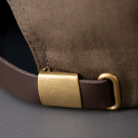 all-groups The back strap and brass clasp with hide away hole from Blvnk Headwear's Roam Strapback in the Buck color way.