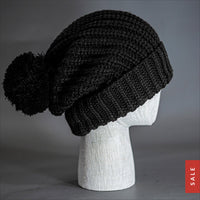Blvnk Sundance Beanie in Black is an extra long super slouchy cuffed blank beanie with a chunky knit and oversized pom pom. Now on Sale at blvnkheadwear.com