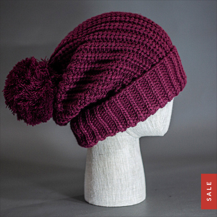 Blvnk Sundance Beanie in Burgundy is an extra long super slouchy cuffed blank beanie with a chunky knit and oversized pom pom. Now on Sale at blvnkheadwear.com