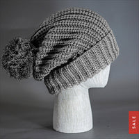 Blvnk Sundance Beanie in Heather Grey is an extra long super slouchy cuffed blank beanie with a chunky knit and oversized pom pom. Now on Sale at blvnkheadwear.com