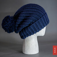 Blvnk Sundance Beanie in Navy is an extra long super slouchy cuffed blank beanie with a chunky knit and oversized pom pom. Now on Sale at blvnkheadwear.com