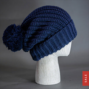 Blvnk Sundance Beanie in Navy is an extra long super slouchy cuffed blank beanie with a chunky knit and oversized pom pom. Now on Sale at blvnkheadwear.com