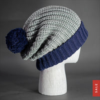Blvnk Sundance Beanie in Stone and Navy is an extra long super slouchy cuffed blank beanie with a chunky knit and oversized pom pom. Now on Sale at blvnkheadwear.com
