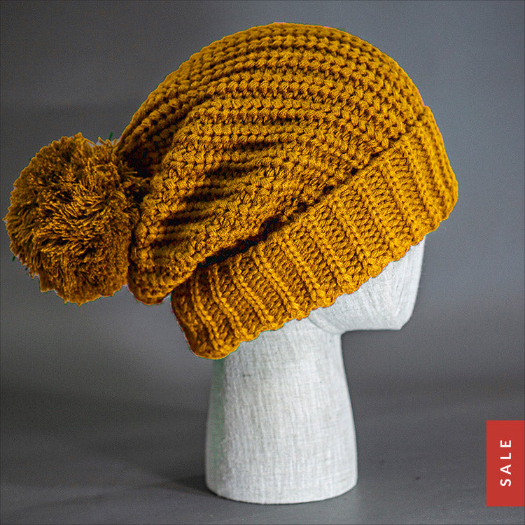 Blvnk Sundance Beanie in Wheat is an extra long super slouchy cuffed blank beanie with a chunky knit and oversized pom pom. Now on Sale at blvnkheadwear.com