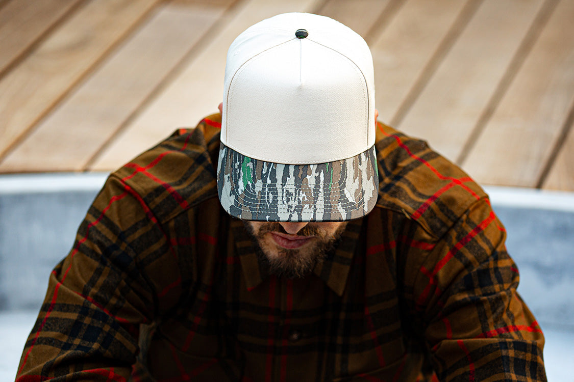 all-groups Blvnk Headwear Origin Vintage Shape blank Snapback in Natural and Realtree Original Camo on man in a flannel.
