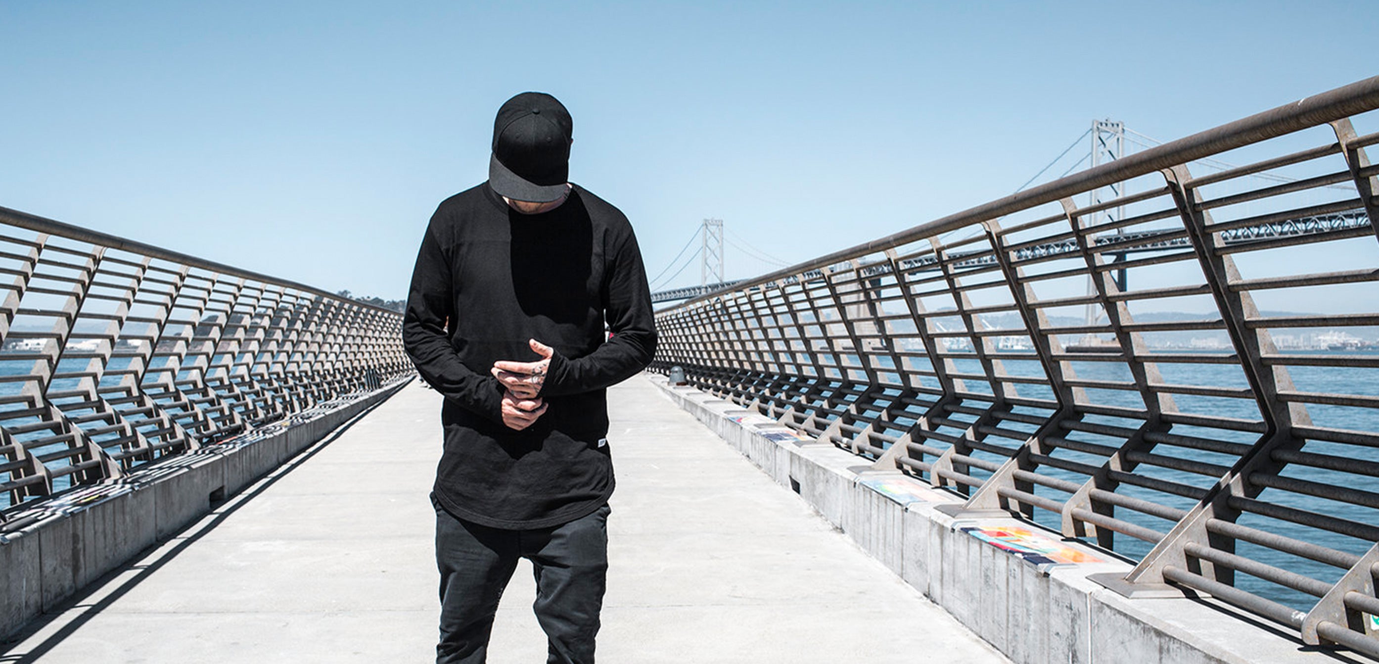 Blvnk Heritage flat bill blank snapback hat on man near The Bay Bridge.