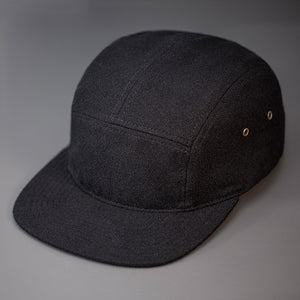 A Warm, Black, Melton Wool, Blank 5 Panel Camp Hat With a Flat Bill, & Leather Strapback. - Designed by Blvnk Headwear.