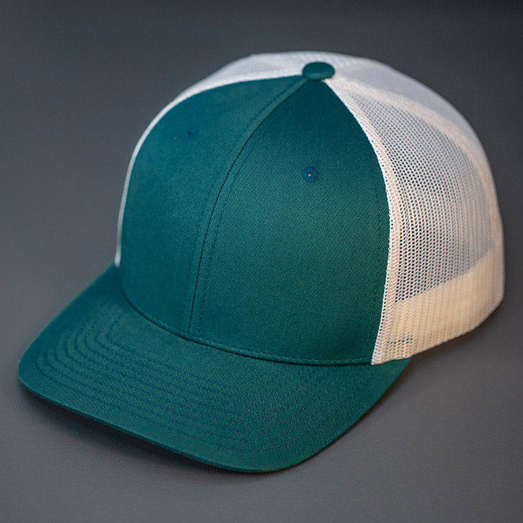 A Deep Teal & Birch, Cotton Twill, Mesh Backed, Blank Trucker Hat with a Pre Curved Bill, & Classic Snapback. | Designed by Blvnk Headwear