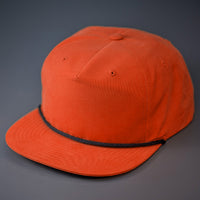 A Rust, Grandpa Style Nylon, Pinch Front, Blank Flat Bill with a Black Rope & Classic Snapback. Designed by Blvnk Headwear.