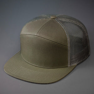 A Dark Loden & Loden, Cotton Twill, Mesh Backed Blank 7 Panel Trucker Hat with a Flat Bill, & Classic Snapback. Designed by Blvnk Headwear