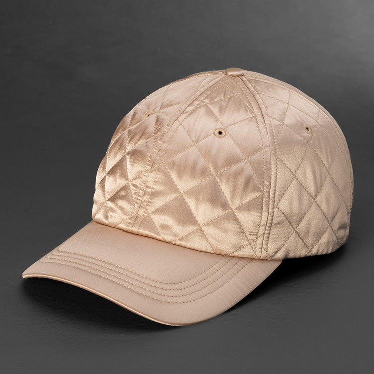 A Champagne colored Quilted Satin, 6 Panel Crown, Blank Dad Hat with matching fabric Back Strap & Brass Clasp by Blvnk Headwear.