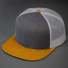 A Heather Charcoal Wool Crown, Blank Trucker Hat, With Aluminum Mesh Back Panels, Biscuit Colored Flat Bill & Classic Snapback. Designed by Blvnk Headwear.