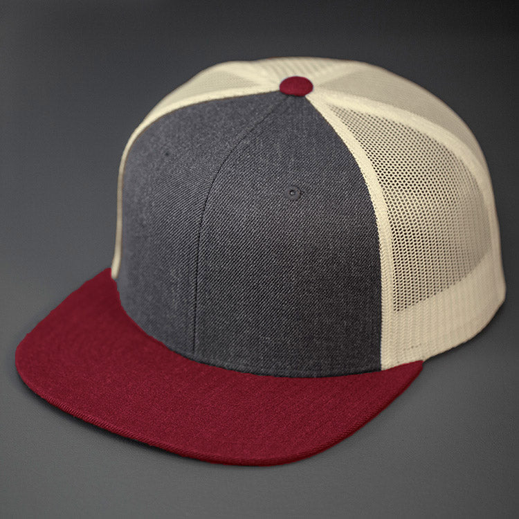 A Heather Charcoal Wool Crown, Blank Trucker Hat, With Birch Mesh Back Panels, Cardinal Colored Flat Bill & Classic Snapback. Designed by Blvnk Headwear.